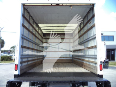 Isuzu NPR HD box truck rear cargo area with empty interior, open back doors showing wooden floor and metal side rails; no visible text or labels.