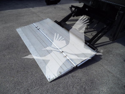 Isuzu NPR HD truck bed ramp platform attached to a lift, metal silver surface with grooves and hinge lines.