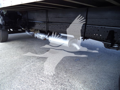 Isuzu NPR HD truck undercarriage showing exhaust system and frame rails with perforated crossmember.