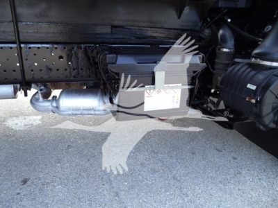 Underbody view of a 2020 Isuzu NPR HD showing exhaust pipe and a rectangular component with labels near a cross-member.
