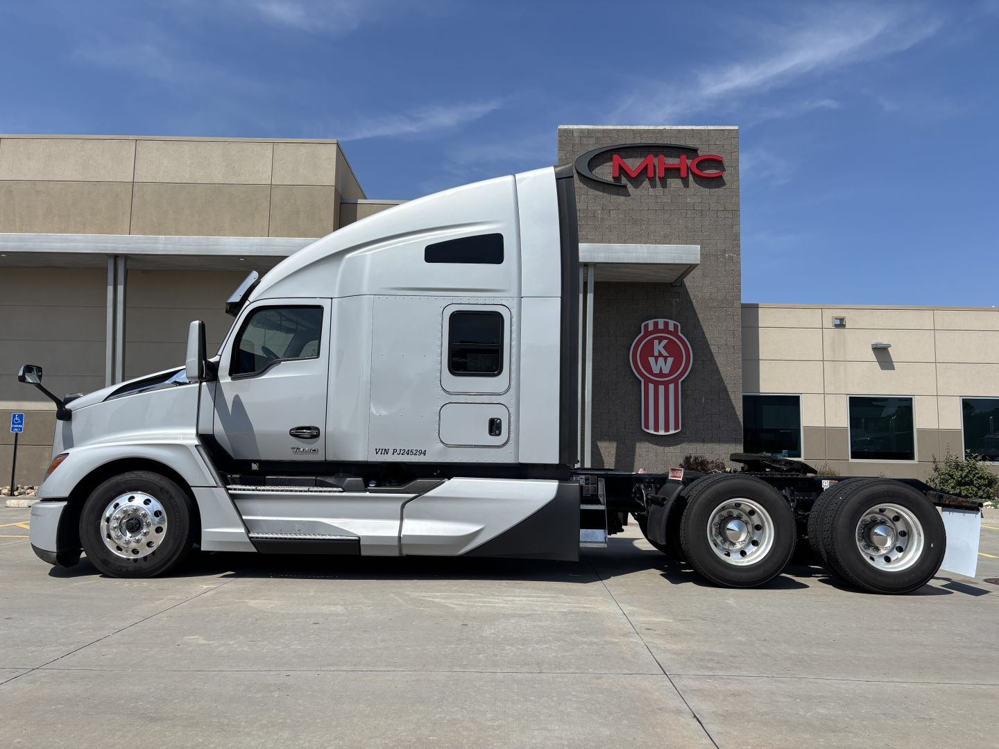 Kenworth T680 truck side view showing cab and chassis with KW logo on the rear panel.