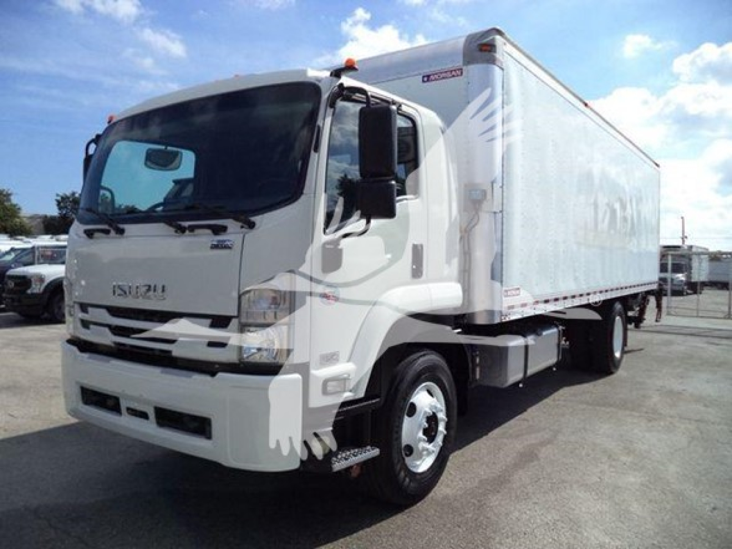 Isuzu FTR box truck in view showing cab and cargo box