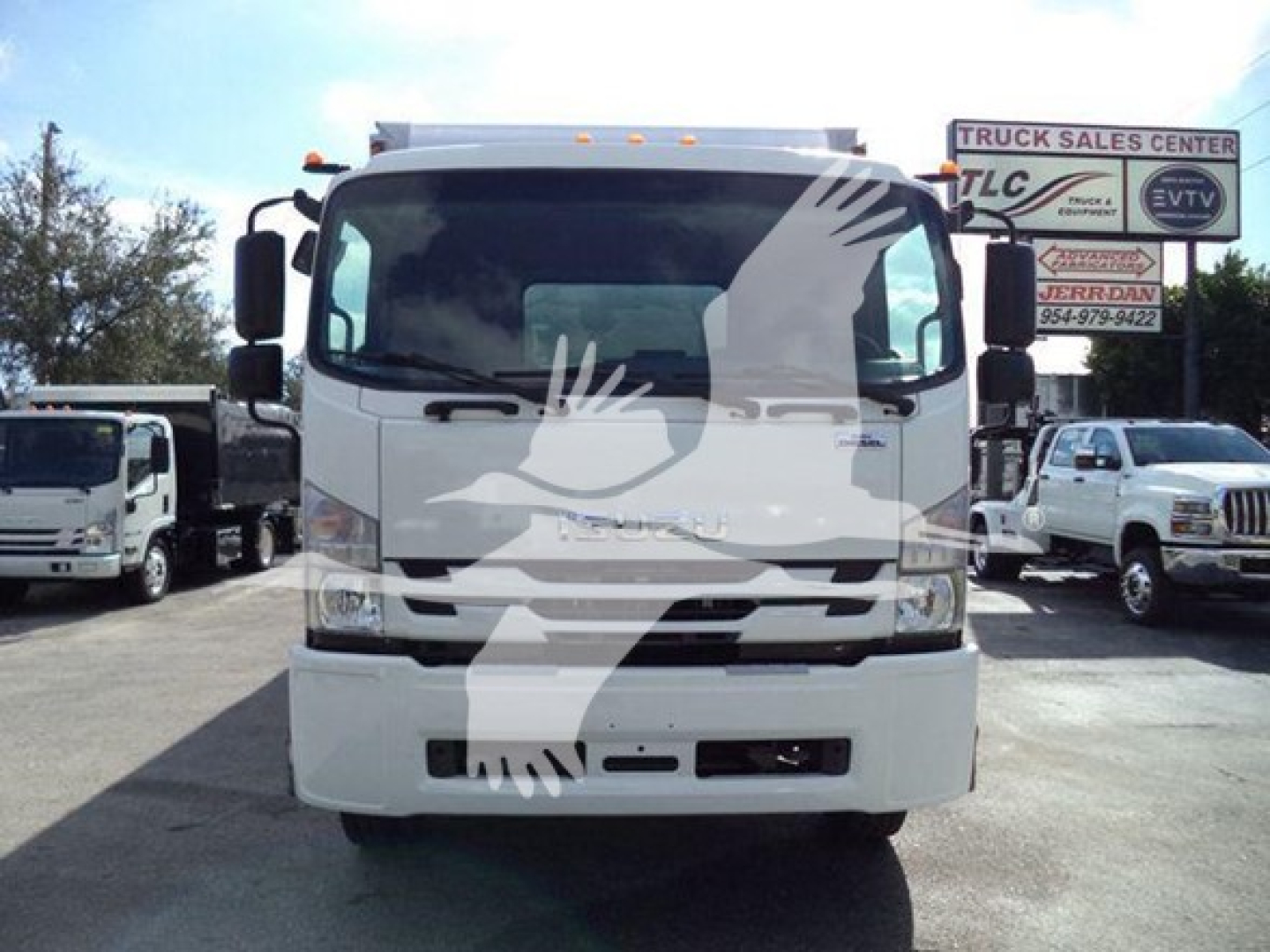 Isuzu box truck front view showing cab with windshield, headlights, and grille. Overlay watermark of a dove. No visible text on the truck itself.