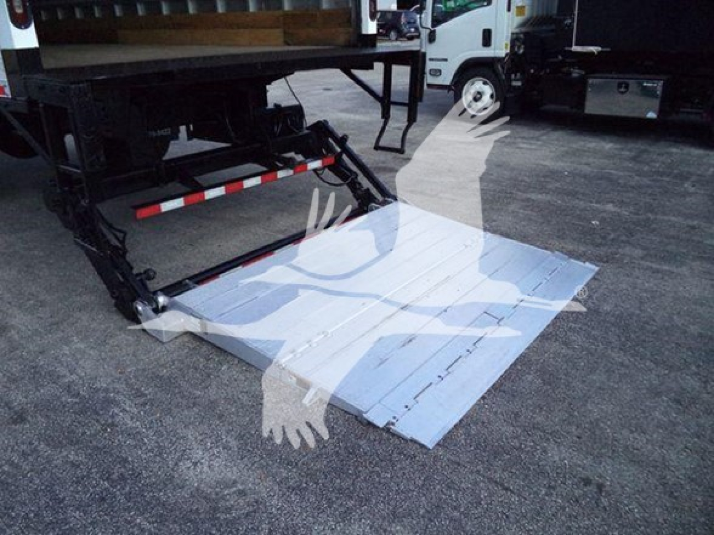 Isuzu FTR truck with a liftgate deployed, metal platform extended on rear of truck.