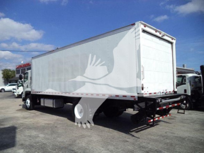 Isuzu FTR box truck rear/side view showing cargo box and rear bumper; white exterior with minimal branding; raised cargo doors