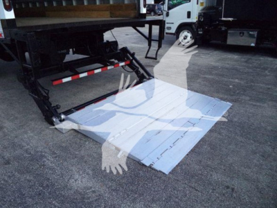 Isuzu FTR truck with a liftgate deployed, metal platform extended on rear of truck.
