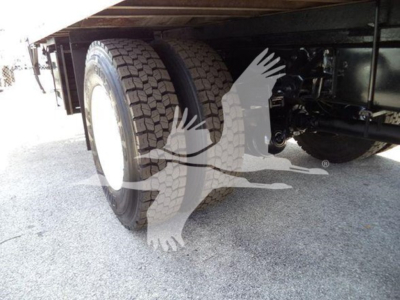 Isuzu FTR rear dual tires and undercarriage showing suspension and wheel wells.