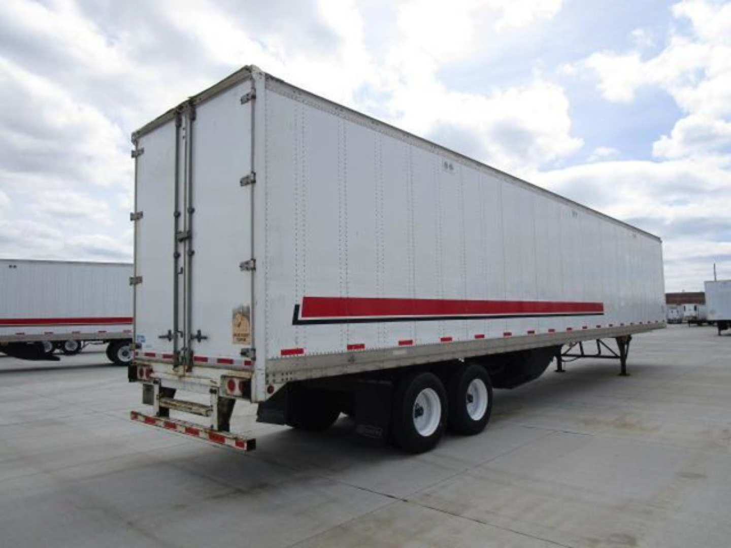  trailer shows a 2014 Stoughton van trailer with white exterior and a red reflective stripe, dual rear doors, and dual tires on the left side.
