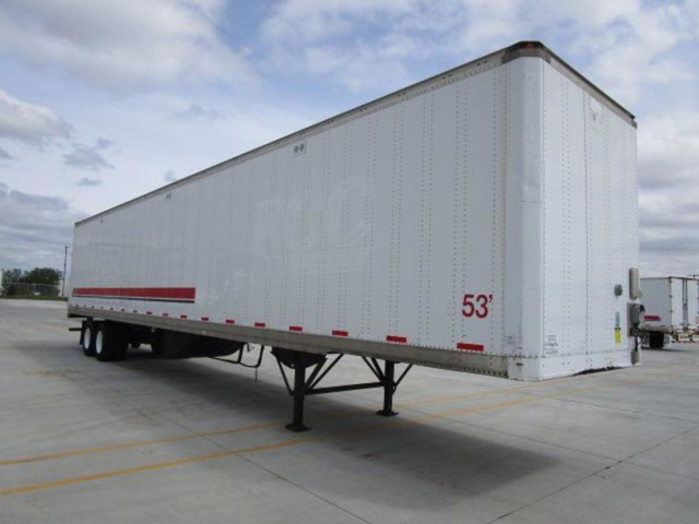 Stoughton 53' van trailer on leveled lot showing side and front corner with landing gear and wheel view.