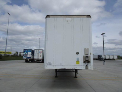 Rear view of a white Stoughton van trailer with reflective panels, taillight area, and electrical connection box on the right side; no legible serial numbers or brand marks readable.