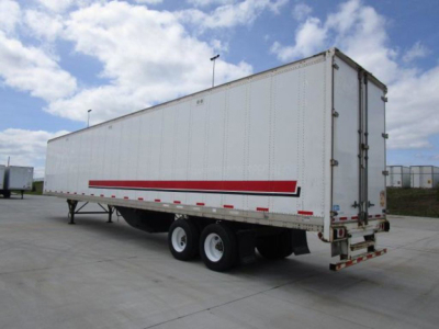 Trailer side and rear view showing a white Stoughton van trailer with a red stripe, dual rear axles, and rear doors.