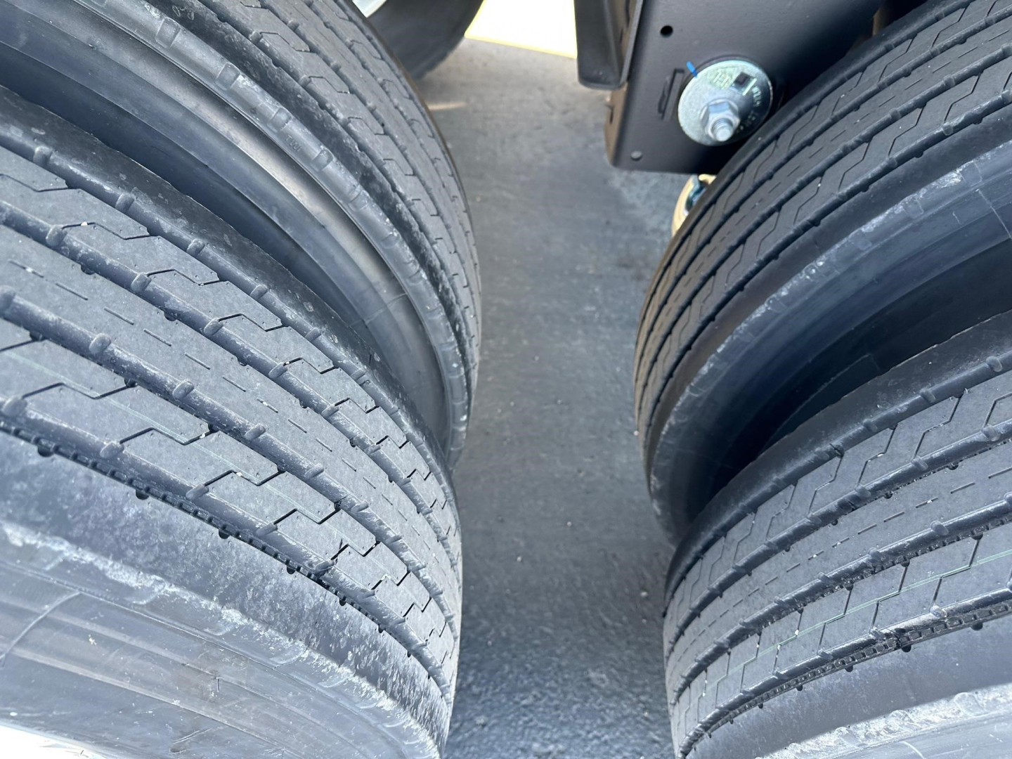 Timpte hopper trailer tires and suspension showing dual axle setup and wheel tread.