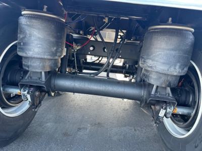 Trailer rear view showing air springs and suspension beam of a Timpte hopper trailer.