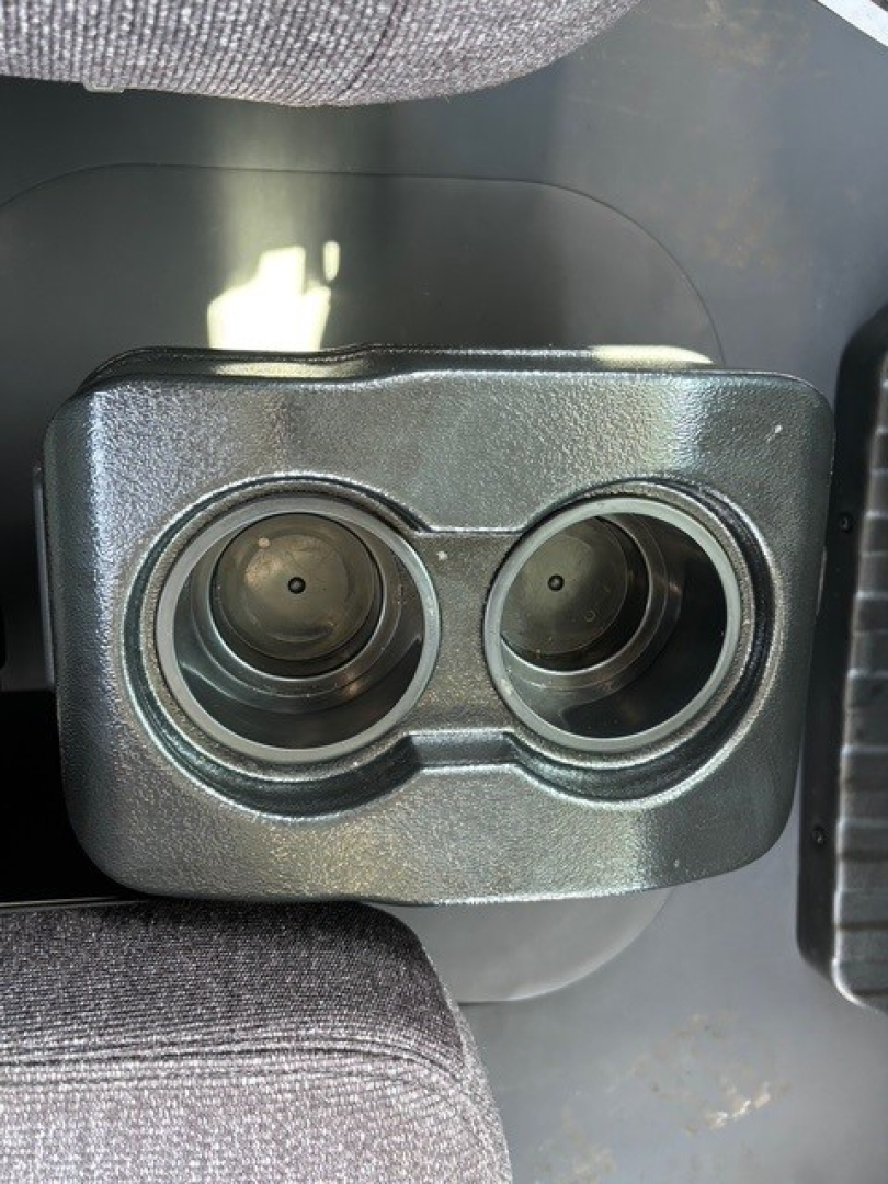 Twin circular instrument/controls on a Mack MD6 dashboard panel showing two round openings.