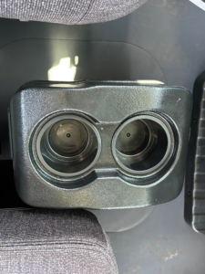 Twin circular instrument/controls on a Mack MD6 dashboard panel showing two round openings.