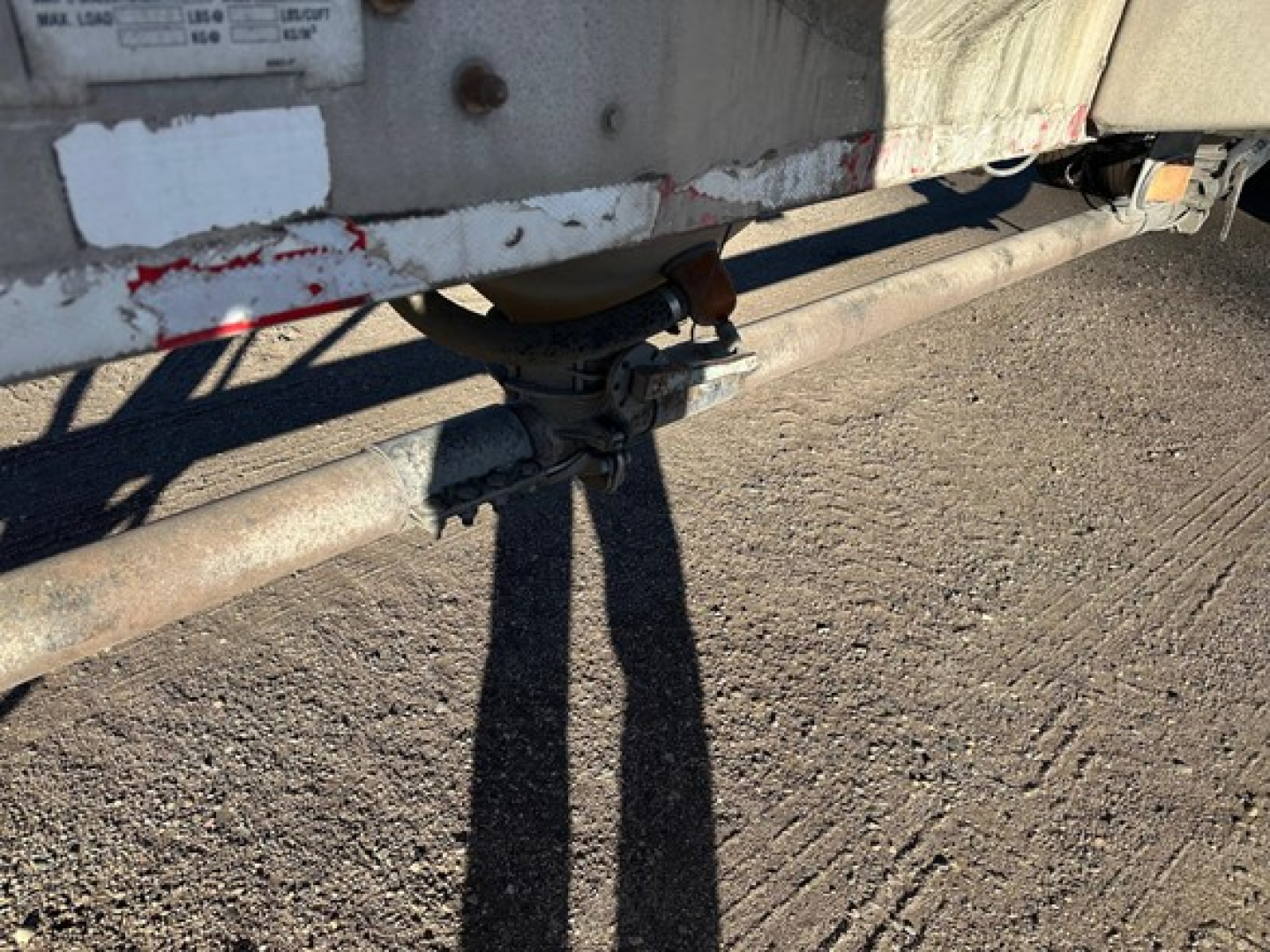 Trailer undercarriage showing valve assembly and piping for a Heil pneumatic dry bulk trailer.