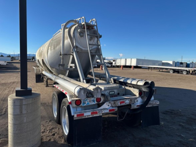  Heil Pneumatic trailer back view showing rear bumper, mud flaps, and ladder with hoses and valves. 
