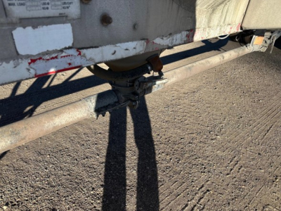 Trailer undercarriage showing valve assembly and piping for a Heil pneumatic dry bulk trailer.