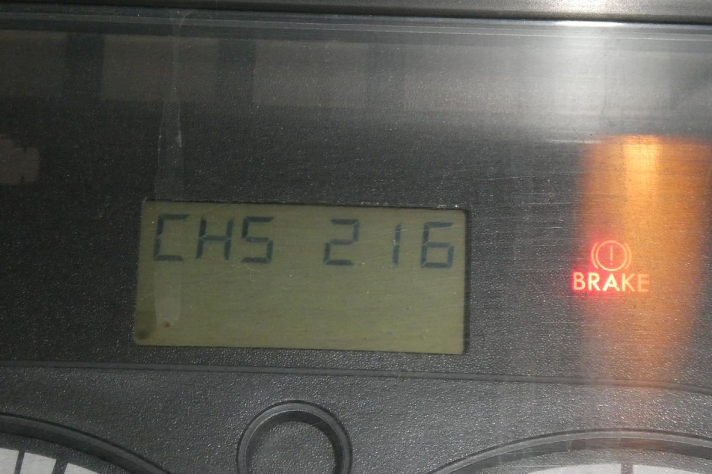 Dash display showing 'CH5 216' and brake indicator icon on Freightliner Cascadia instrument cluster.
