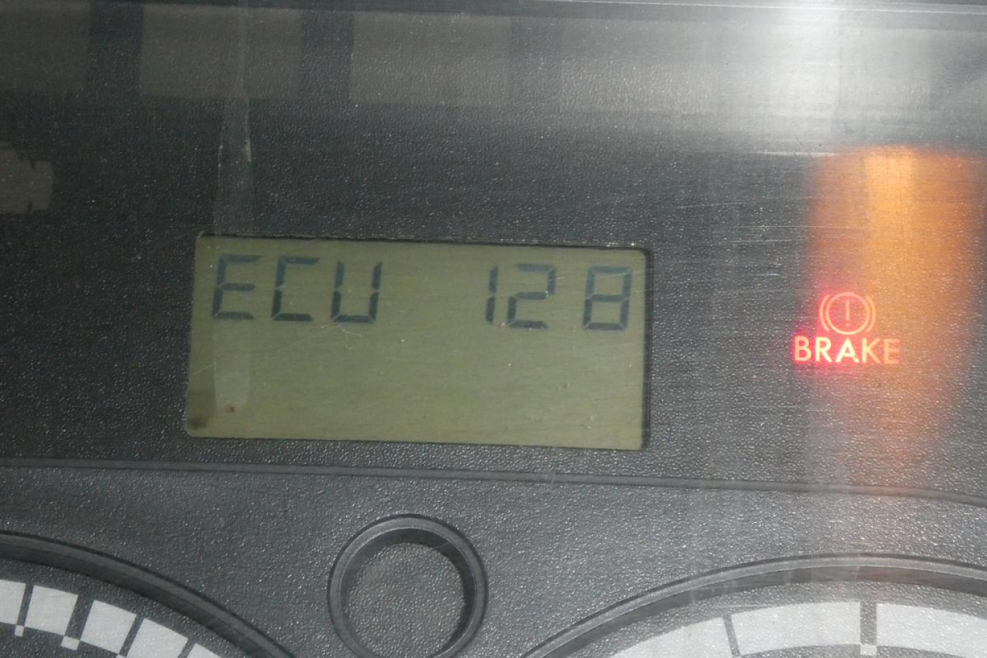 Dashboard display showing ECU 128 and Brake light symbol on a Freightliner Cascadia instrument cluster.