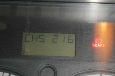 Dash display showing 'CH5 216' and brake indicator icon on Freightliner Cascadia instrument cluster.