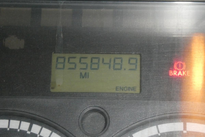 Dashboard display showing odometer 855848.9 miles and ENGINE warning light illuminated on a Freightliner Cascadia 113 cluster.
