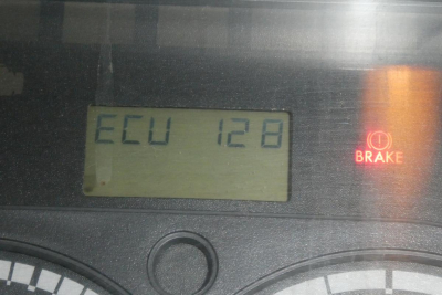 Dashboard display showing ECU 128 and Brake light symbol on a Freightliner Cascadia instrument cluster.