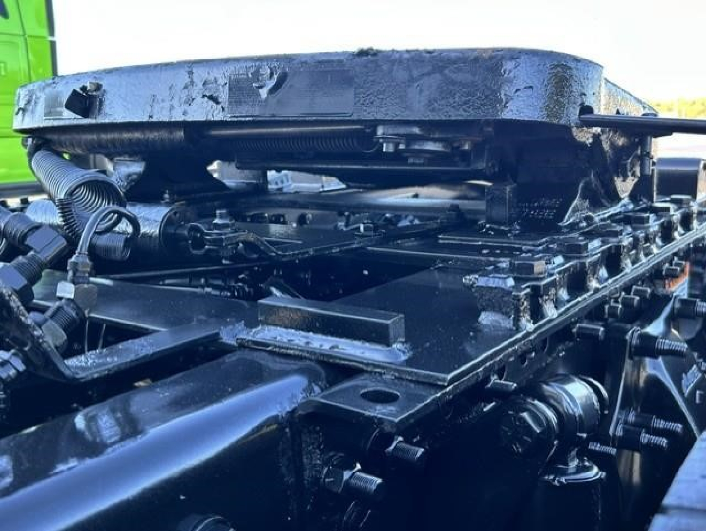 Freightliner Cascadia 126 chassis frame rail with engine and components visible, top view showing structural beams and mounting hardware.