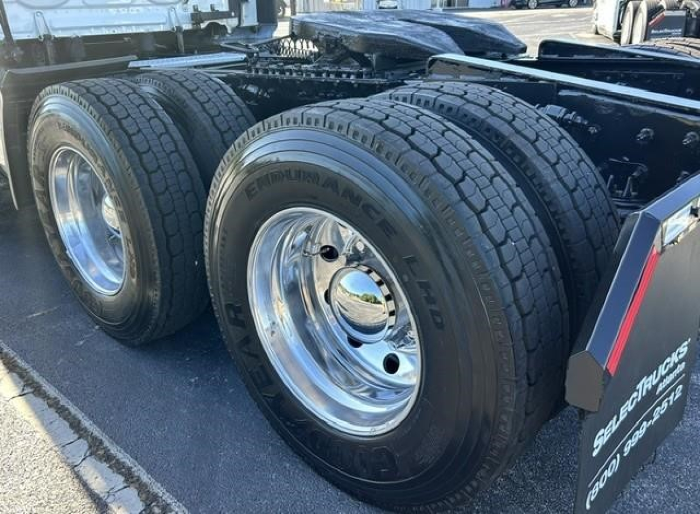 Freightliner Cascadia chassis showing dual rear wheel tires and chrome rims.