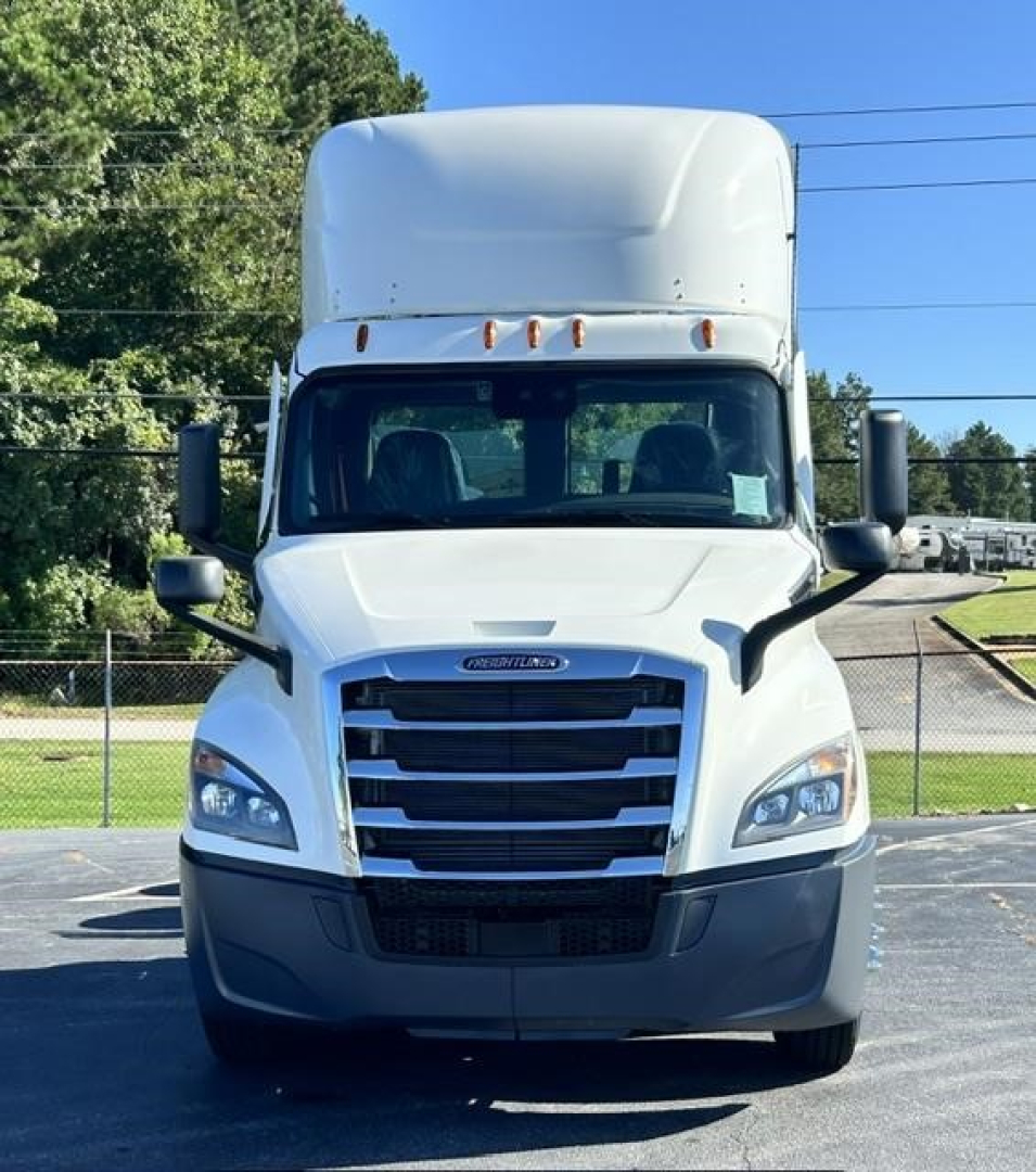 Truck front view of 2021 Freightliner Cascadia 126 with high roof sleeper, daylight reflection on chrome grille, and large side mirrors.