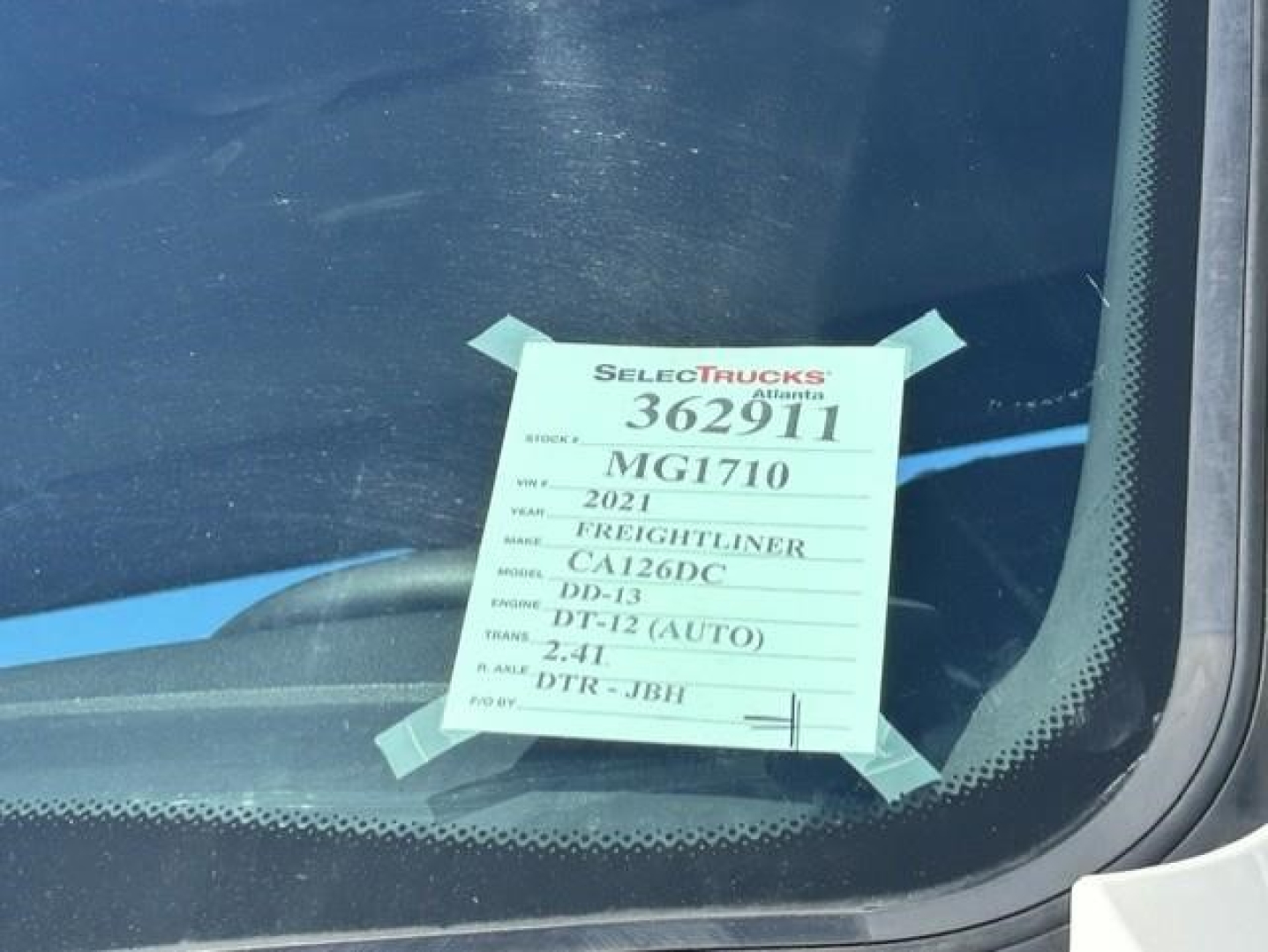 Tag on windshield showing stock number 362911, model MG1710, year 2021 Freightliner Cascadia 126 Day Cab truck.