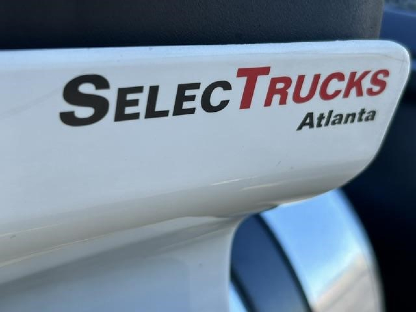 SelectTrucks Atlanta logo on vehicle seat in a Freightliner Cascadia 126 interior showing branding text.