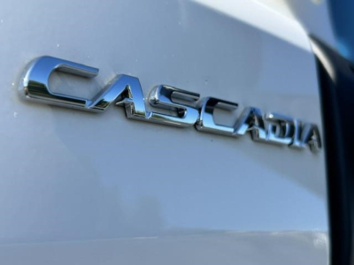 Casadia/Cascadia badge on a Freightliner Cascadia 126 truck showing chrome CAST branded lettering on a light exterior.