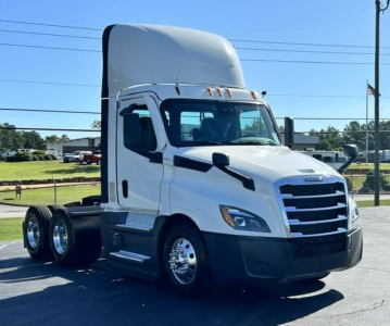 Truck cab exterior of a Freightliner Cascadia 126 day cab tractor in white, front three-quarter view.
