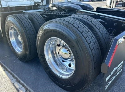 Freightliner Cascadia chassis showing dual rear wheel tires and chrome rims.