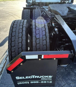 Freightliner Cascadia 126 chassis showing dual rear axles and fifth wheel area with black mudguards and red/white reflective markers.