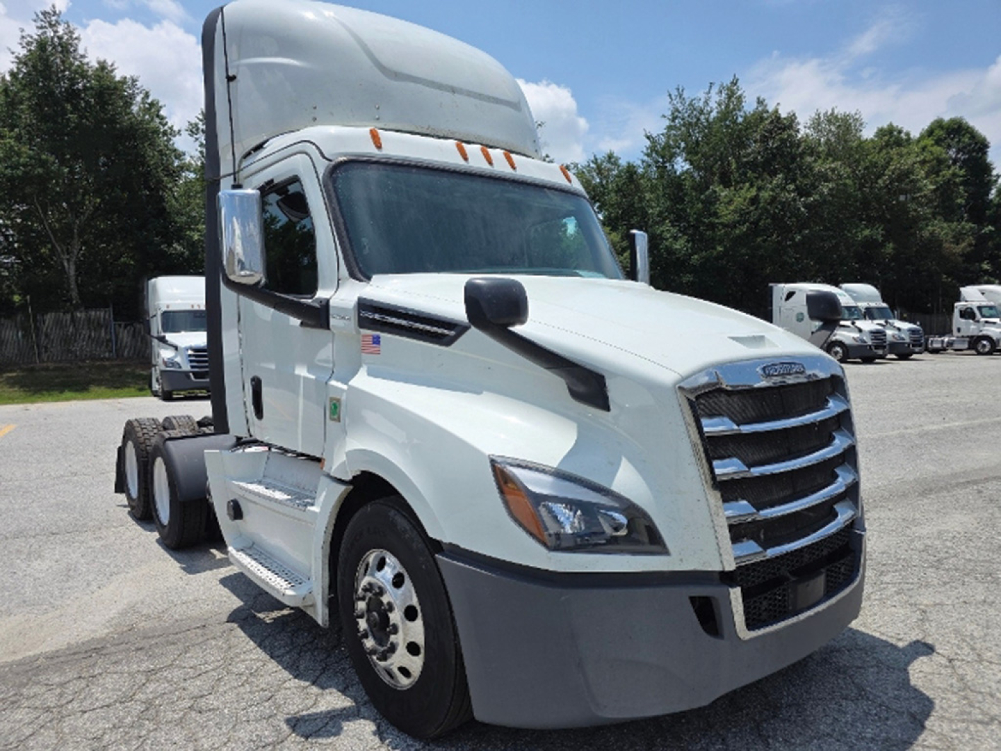 Truck front-left view of 2020 Freightliner Cascadia126 sleeper cab tractor showing large grille, headlights, and white exterior.