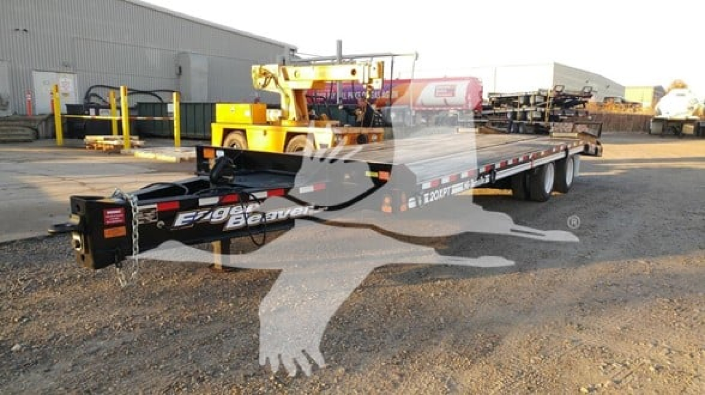 Flatbed trailer with EZ Loader branding and wheel ramps, showing 'Eager Beaver' and model text on frame.