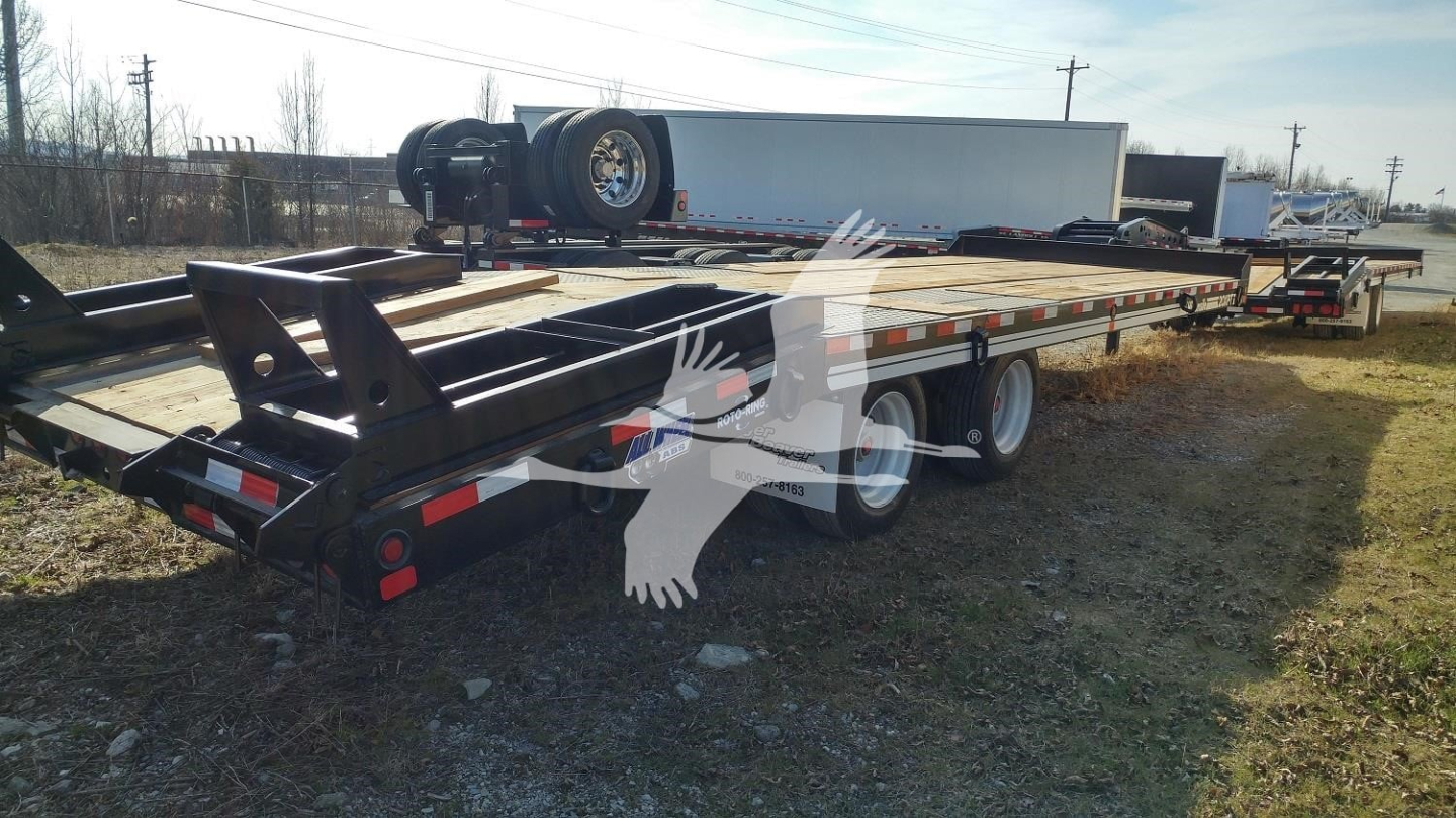 Trailer chassis of a new 2026 Eager Beaver 20XPT flatbed trailer showing dual rear axles and spare wheel with branding.