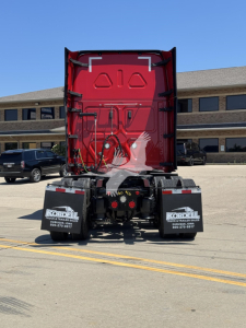 Truck rear view showing red cab and black bumper with Kordell Mudflaps and dual exhaust guard