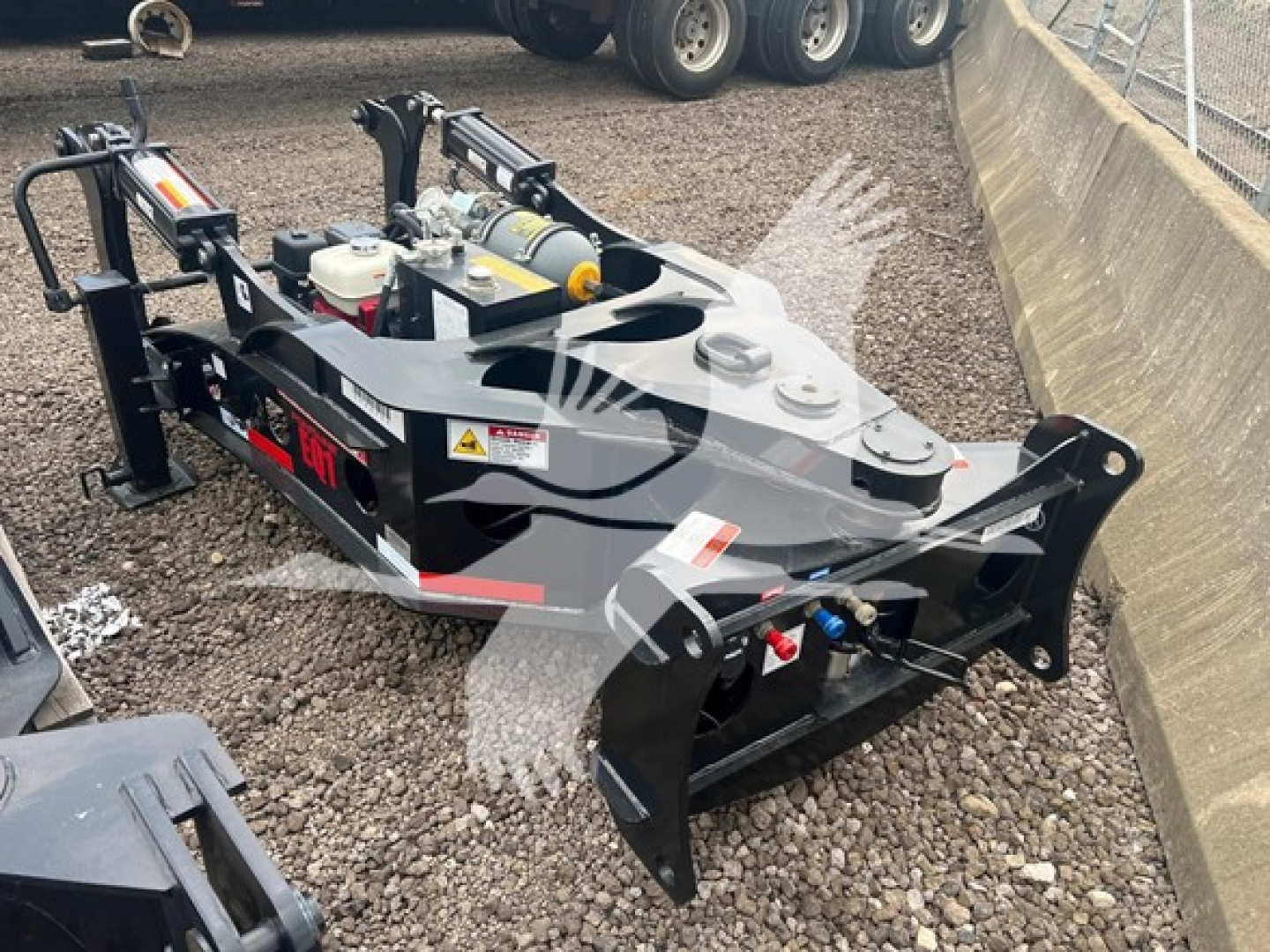 Fontaine 55Mx lowboy trailer front mount with hydraulic system and hydraulic jack, visible warning decals and control components, on gravel surface.