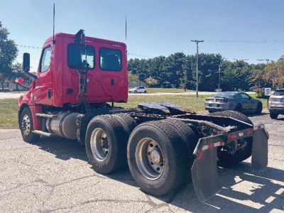 Truck chassis and cab of a 2019 Freightliner Cascadia126 in view from left-rear showing the tractor, rear dual axles, and mud flaps.
