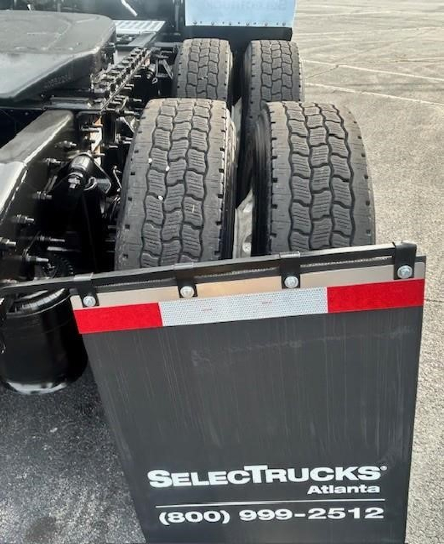 Truck rear view showing dual rear axles and mudguard with SelectTrucks Atlanta logo and contact number.