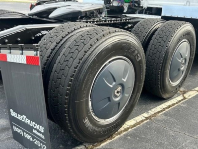 Freightliner Cascadia 126 tandem rear wheels on a used truck chassis showing dual-axle configuration and wheel covers.
