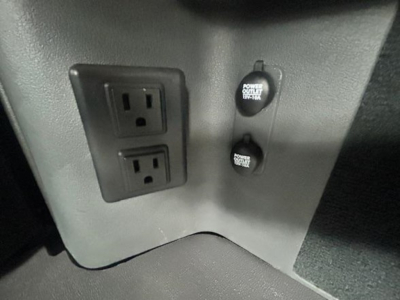 Sticker-free image showing a Freightliner Cascadia dash area with two power outlets and two 12V 'Power Outlet' sockets.