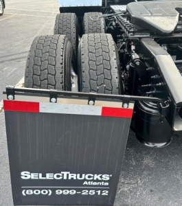 Freightliner Cascadia rear view showing dual rear axles and wheels with SelectTrucks Atlanta branding plate and contact number.