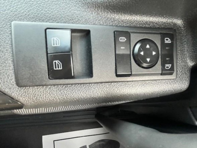 Interior control panel showing window switch and side mirror joystick on Freightliner Cascadia truck.