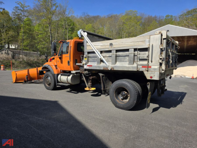 2006 International WorkStar 7500 dump truck with plow, wing, and aluminum sander attachment in a parking lot.