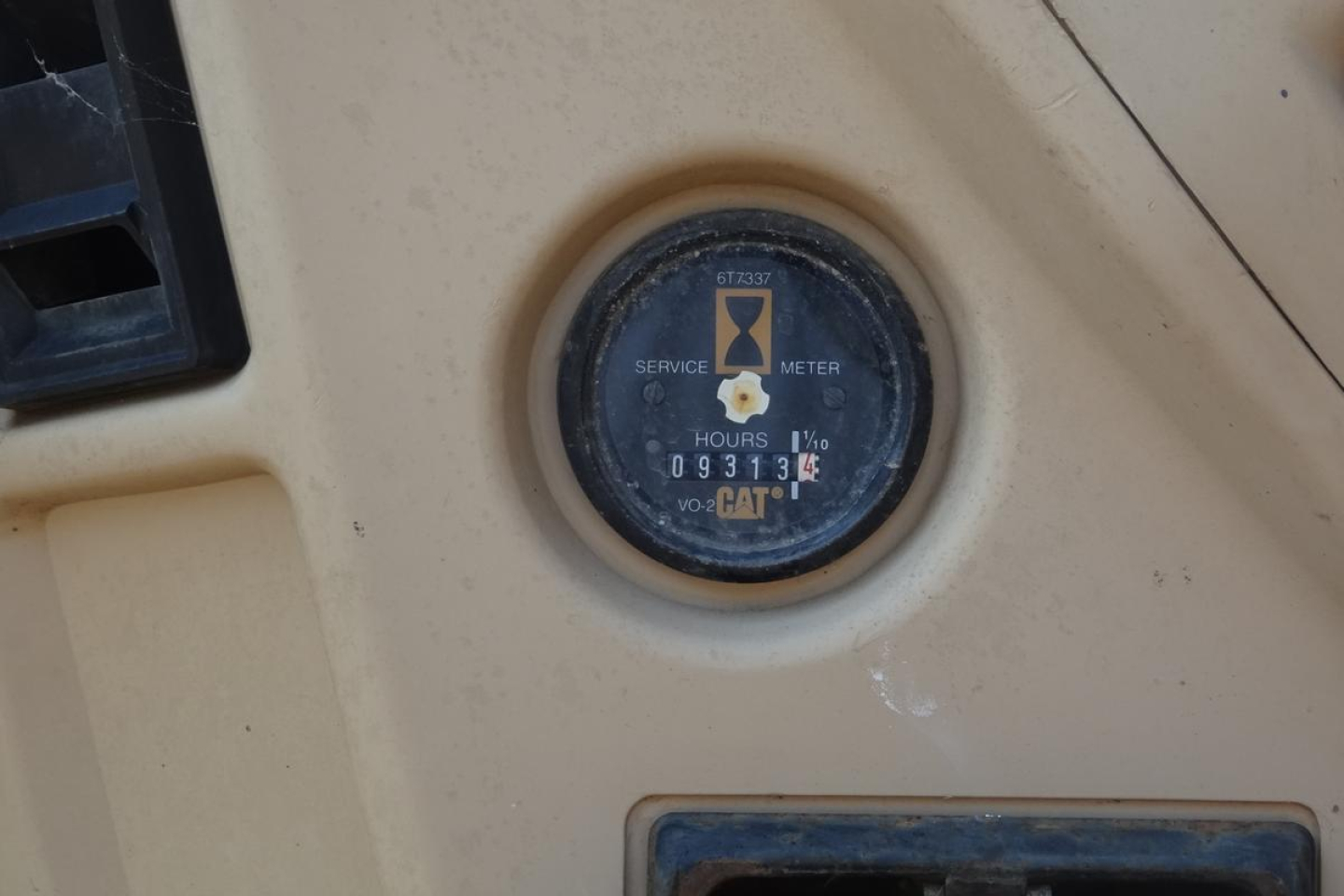Caterpillar 312 excavator dashboard gauge showing service meter hours (093131) and CAT logo.