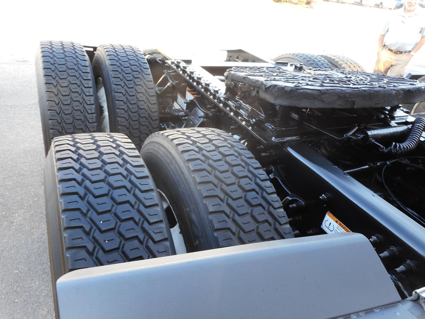 Truck chassis with dual rear axles and tires visible, Freightliner Cascadia 126 cabless chassis frame area